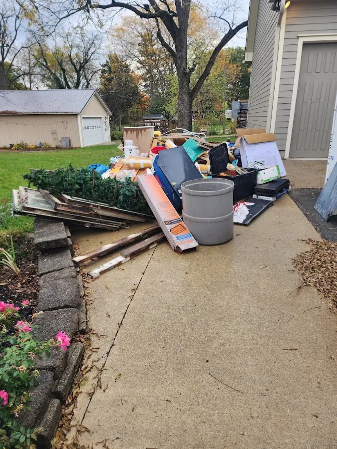 Dumpster being loaded with debris for 12 Yard Dumpster Rental in Hanover